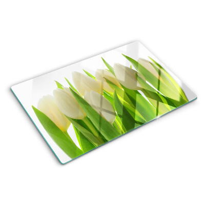 Tabla de cortar Tulipanes sobre un fondo de hojas verdes.