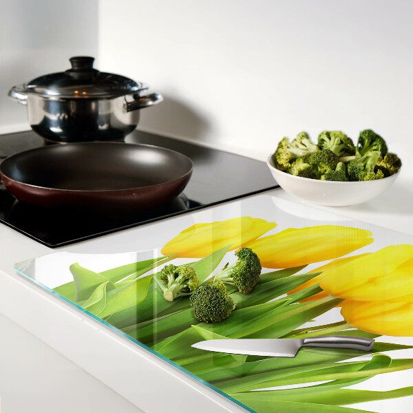 Tabla de cortar de cristal Tulipanes amarillos sobre fondo verde