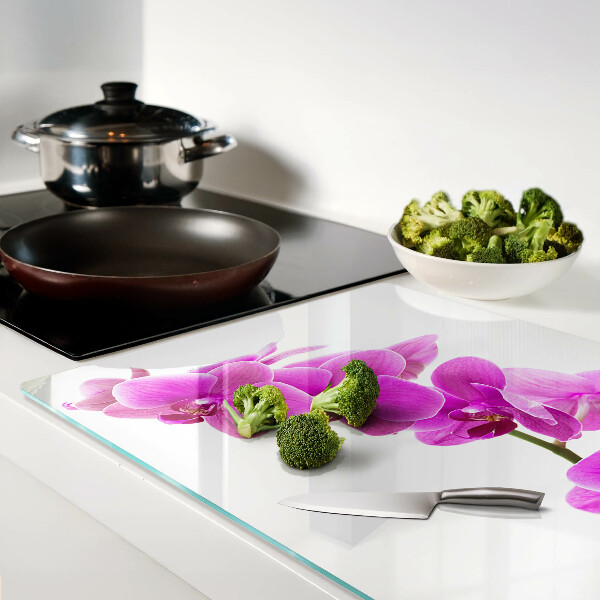 Tabla de cortar de cristal Flores de orquídea en tonos rosas.