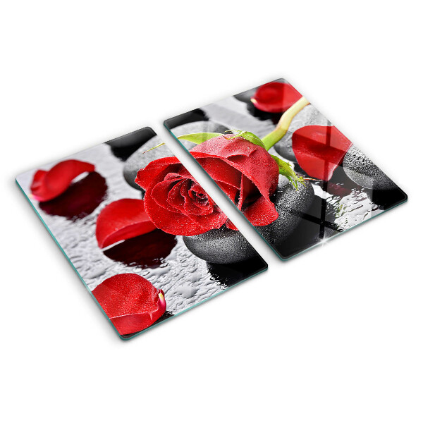 Szklana deska kuchenna Róża na kamieniach z kroplami wody