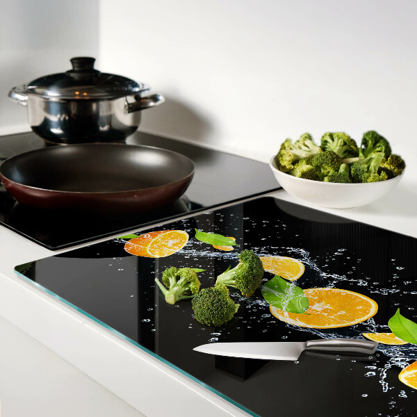 Tabla de cortar de cristal Frutas cítricas en agua