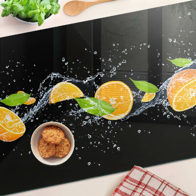 Tabla de cortar de cristal Frutas cítricas en agua