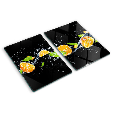 Tabla de cortar de cristal Frutas cítricas en agua