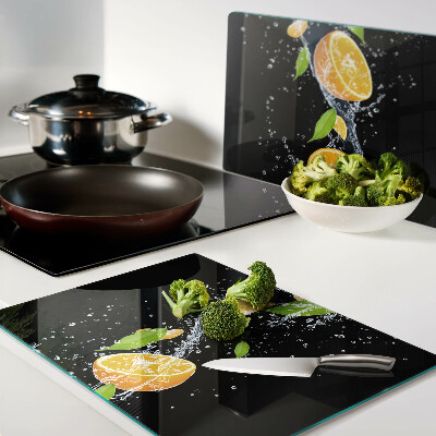 Tabla de cortar de cristal Frutas cítricas en agua