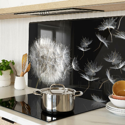 Tabla de cortar de cristal Dientes de león sobre un fondo negro