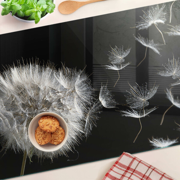 Tabla de cortar de cristal Dientes de león sobre un fondo negro