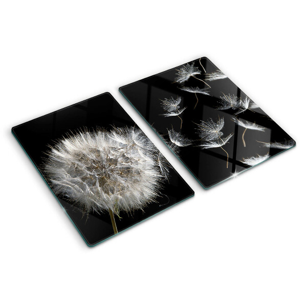 Tabla de cortar de cristal Dientes de león sobre un fondo negro