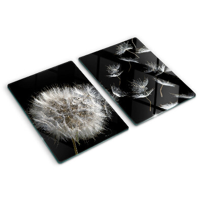 Tabla de cortar de cristal Dientes de león sobre un fondo negro