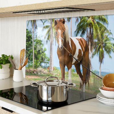 Tabla de cortar Un caballo con palmeras al fondo.