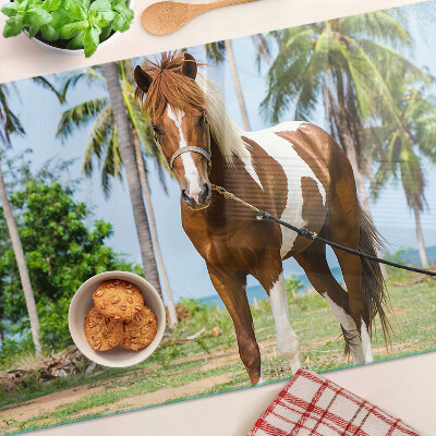 Tabla de cortar Un caballo con palmeras al fondo.