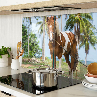 Tabla de cortar Un caballo con palmeras al fondo.