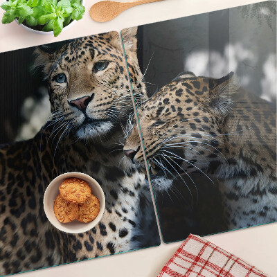 Tabla de cortar de cristal Guepardos sobre un fondo oscuro