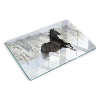 Tabla de cortar Un caballo en un paisaje invernal.