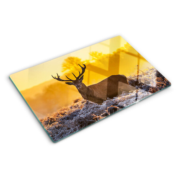 Tabla de cortar Un ciervo con el fondo de un paisaje matutino.