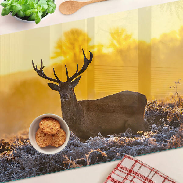 Tabla de cortar Un ciervo con el fondo de un paisaje matutino.