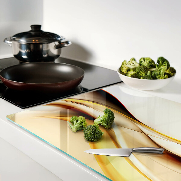 Tabla de cortar de cristal Ondas abstractas en tonos dorados