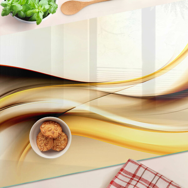 Tabla de cortar de cristal Ondas abstractas en tonos dorados