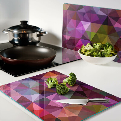 Tabla de cortar de cristal Geometría en tonos rosa y morado.