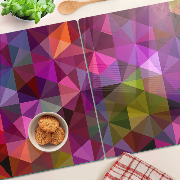 Tabla de cortar de cristal Geometría en tonos rosa y morado.