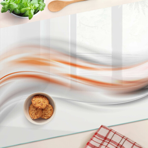 Tabla para cortar Ondas en tonos naranja y gris.