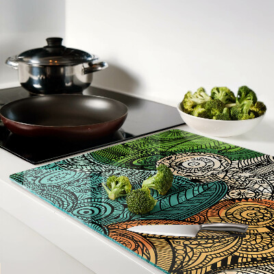 Tabla de cortar Motivo de mandala con patrones coloridos.