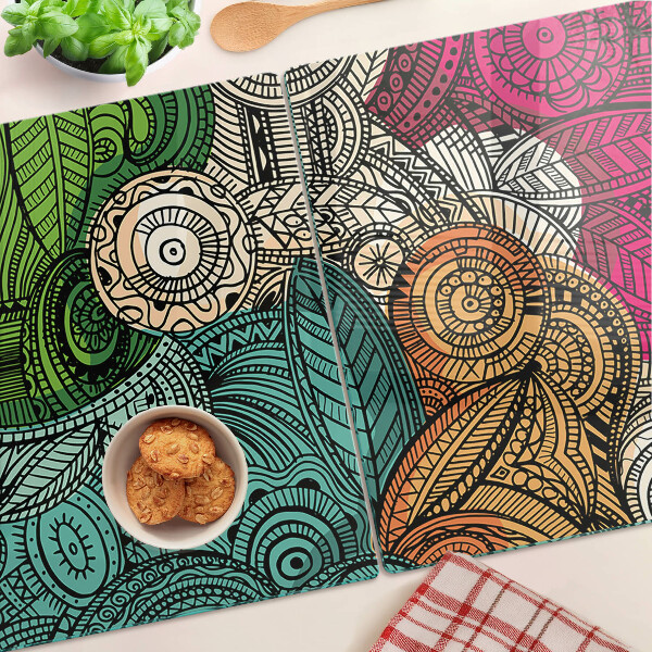 Tabla de cortar Motivo de mandala con patrones coloridos.