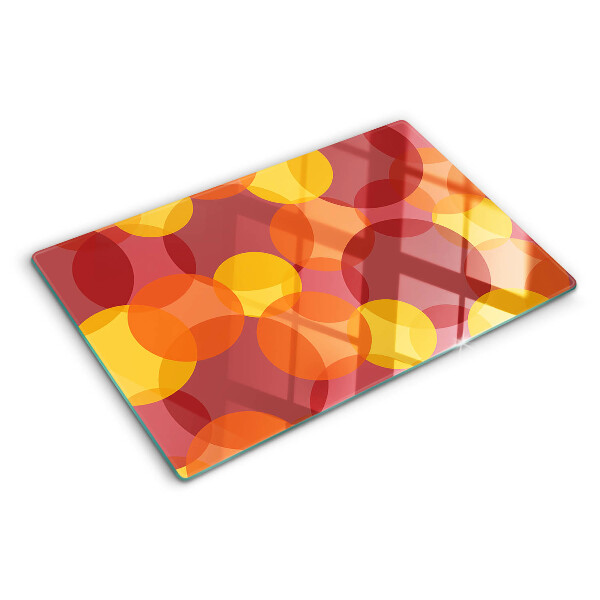 Tabla de cortar de cristal Círculos coloridos en tonos cálidos.