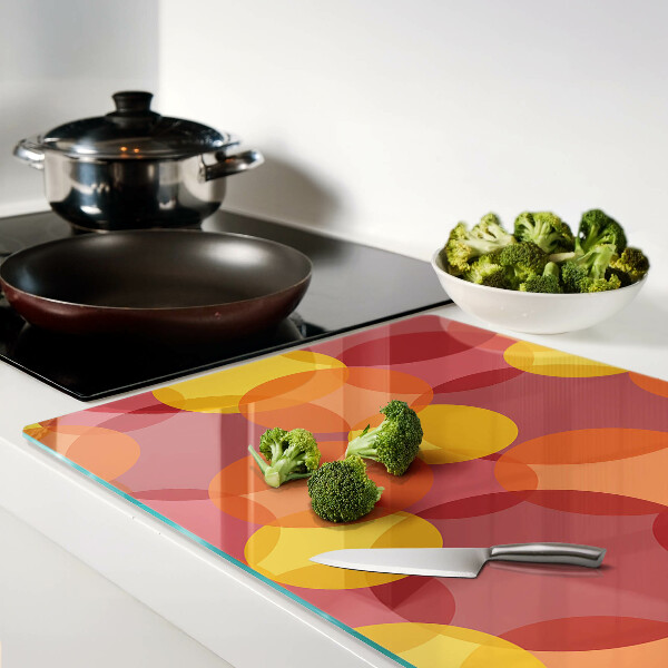 Tabla de cortar de cristal Círculos coloridos en tonos cálidos.