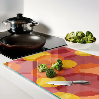 Tabla de cortar de cristal Círculos coloridos en tonos cálidos.