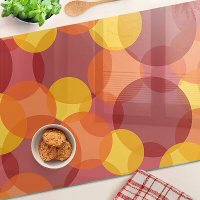 Tabla de cortar de cristal Círculos coloridos en tonos cálidos.