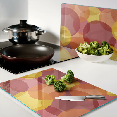 Tabla de cortar de cristal Círculos coloridos en tonos cálidos.