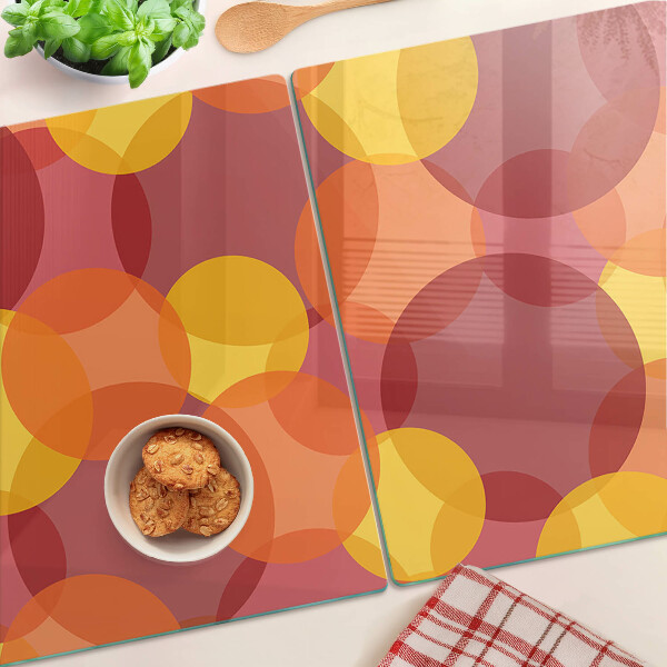 Tabla de cortar de cristal Círculos coloridos en tonos cálidos.