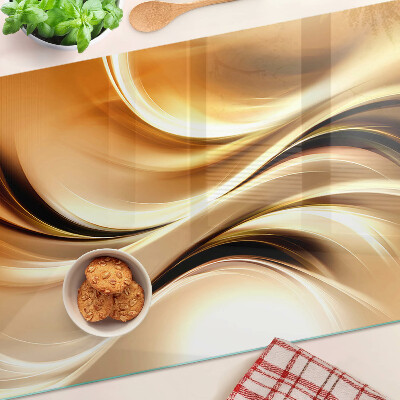 Tabla de cortar de cristal Ondas abstractas en tonos dorados