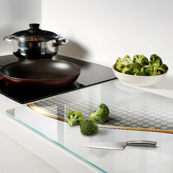 Tabla de cortar de cristal Una ola dorada sobre un fondo de puntos.