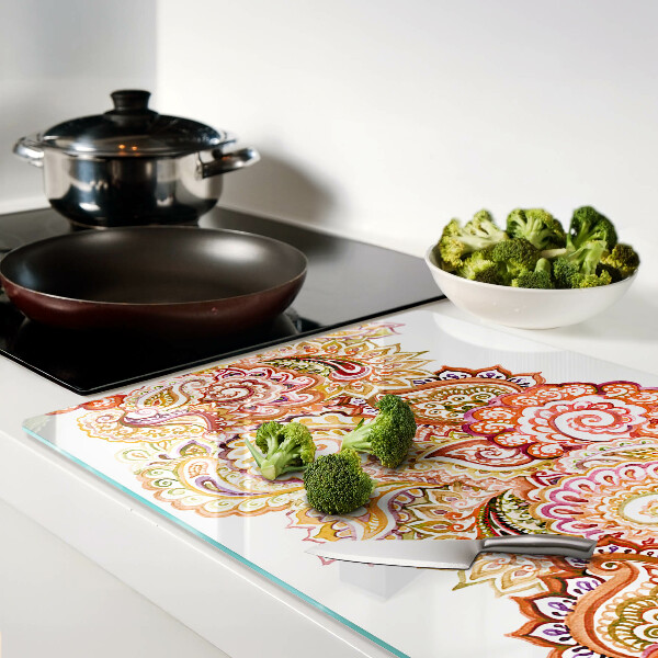 Tabla de cortar de cristal Motivo paisley en tonos rojos y dorados.