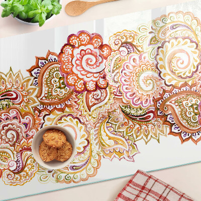 Tabla de cortar de cristal Motivo paisley en tonos rojos y dorados.