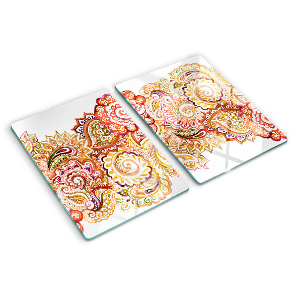 Tabla de cortar de cristal Motivo paisley en tonos rojos y dorados.