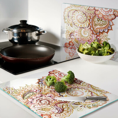 Tabla de cortar de cristal Motivo paisley en tonos rojos y dorados.