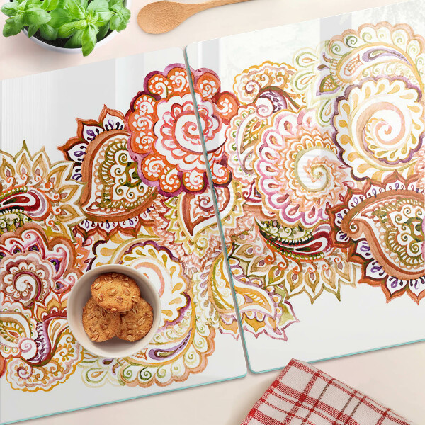 Tabla de cortar de cristal Motivo paisley en tonos rojos y dorados.