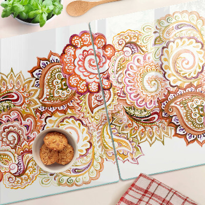Tabla de cortar de cristal Motivo paisley en tonos rojos y dorados.