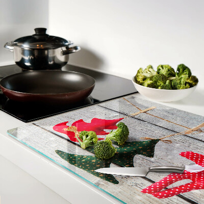 Tabla de cortar Adornos navideños sobre un fondo de madera.