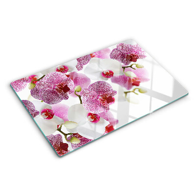 Tabla de cortar de cristal Orquídeas al fondo de la ventana.