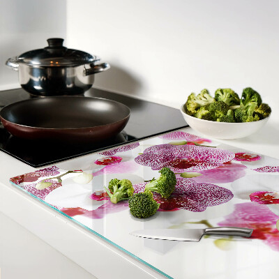 Tabla de cortar de cristal Orquídeas al fondo de la ventana.