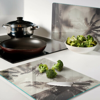 Tabla de cortar de cristal Palmeras sobre un fondo monocromático