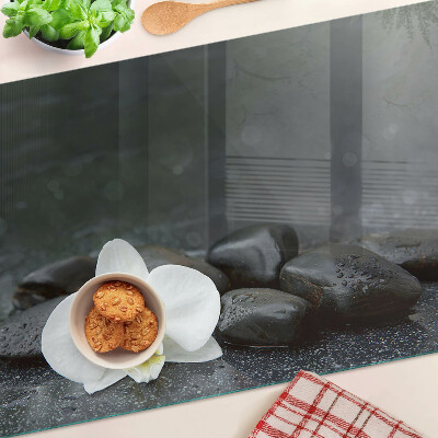 Tabla de cocina Flor de orquídea sobre piedras