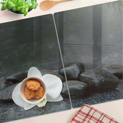 Tabla de cocina Flor de orquídea sobre piedras