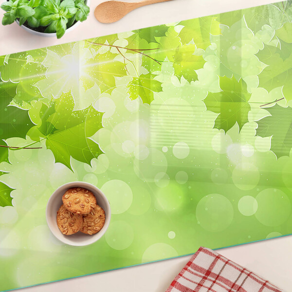 Tabla de cortar de cristal Hojas bajo los rayos del sol