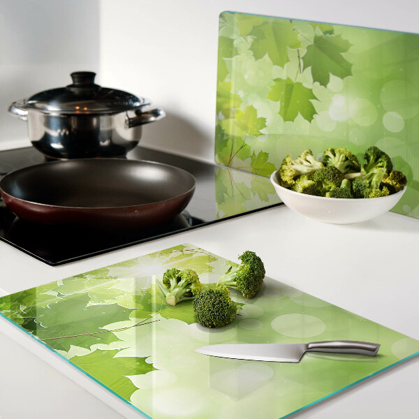 Tabla de cortar de cristal Hojas bajo los rayos del sol