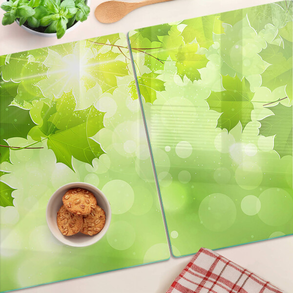 Tabla de cortar de cristal Hojas bajo los rayos del sol