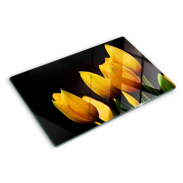 Tabla de cortar de cristal Tulipanes amarillos sobre fondo negro